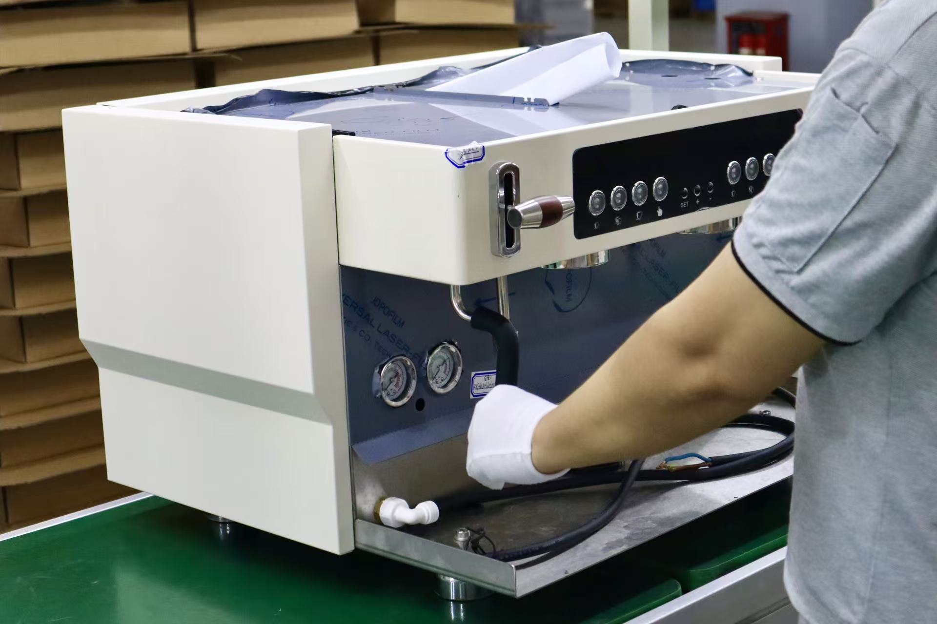 Technician testing steam function on an espresso machine